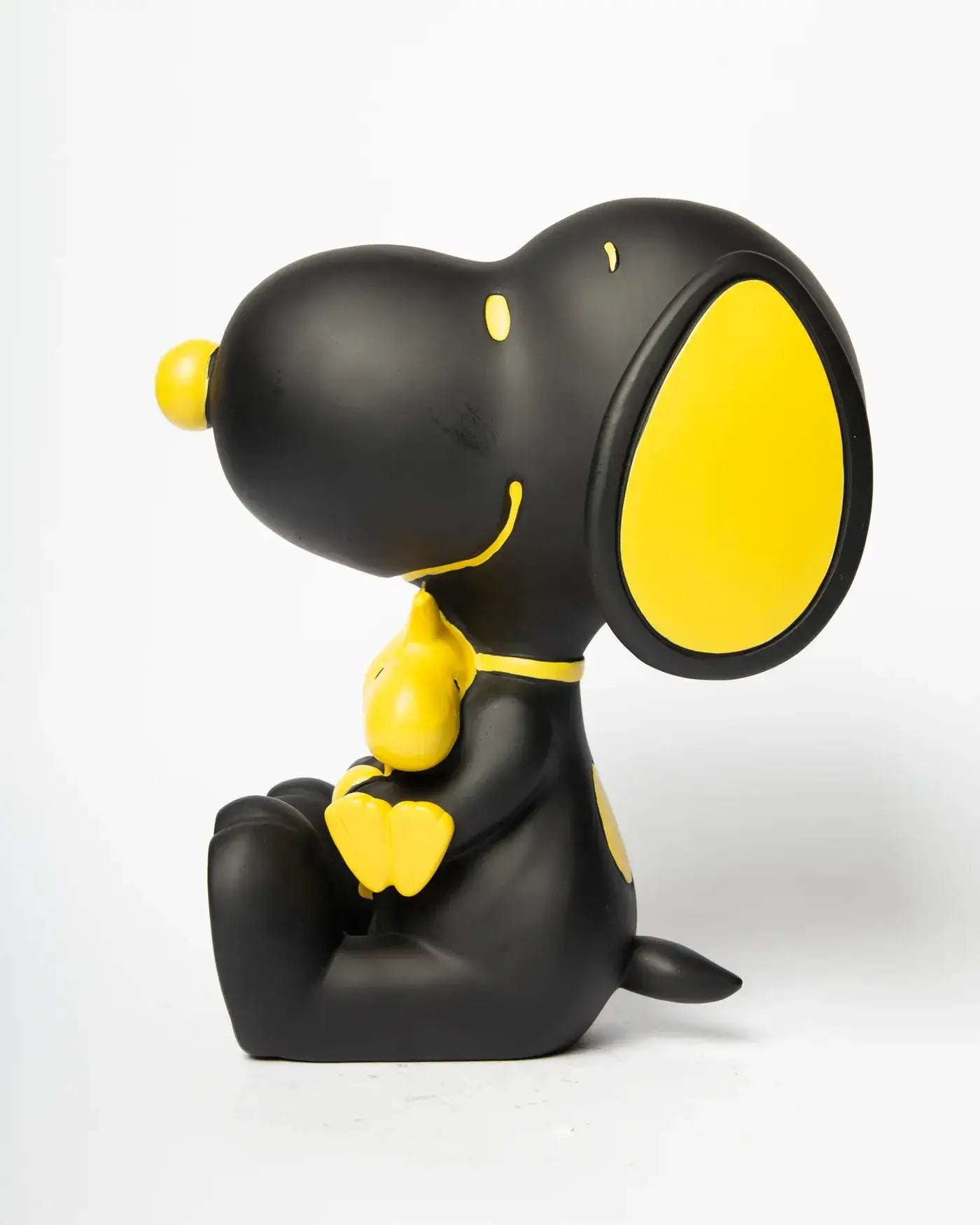 Vue de profil de la figurine Snoopy noir et Woodstock jaune
