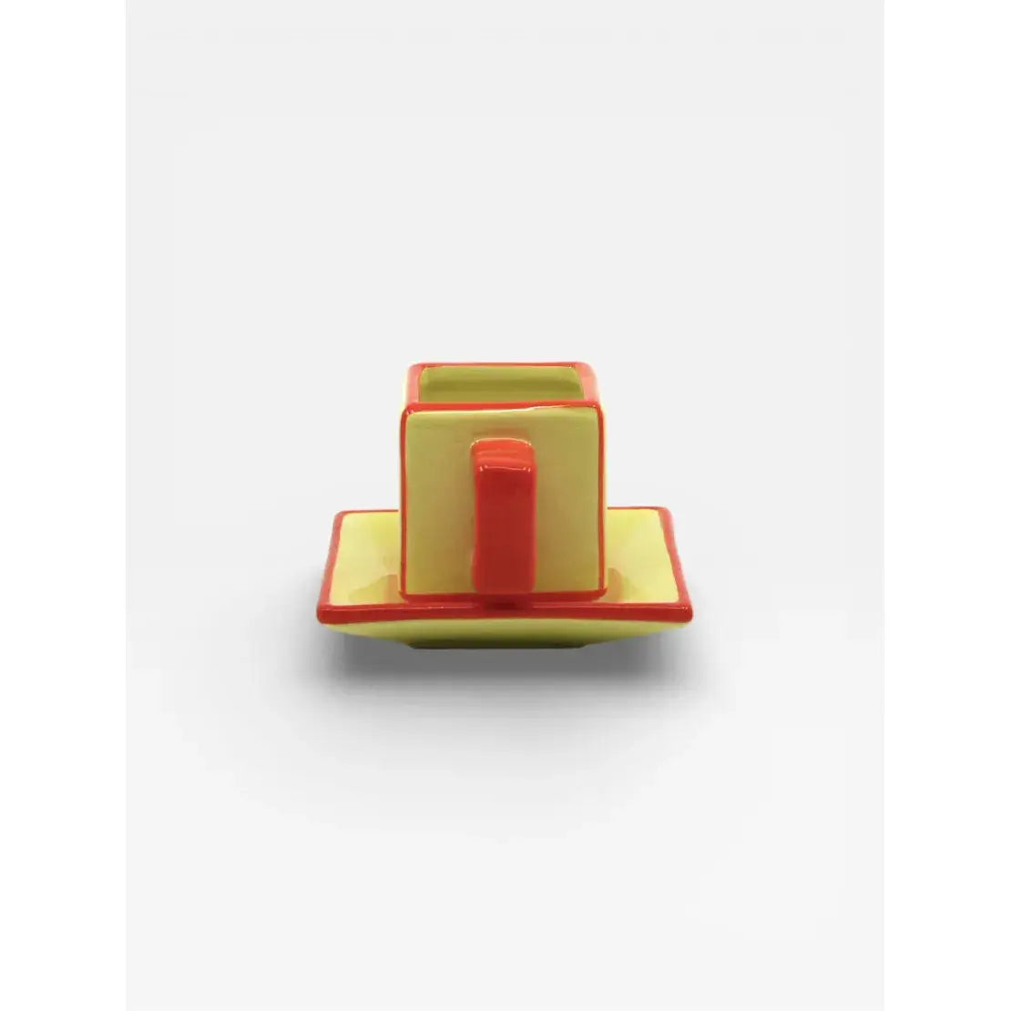 Tasse à café avec soucoupe en céramique jaune et orange design graphique vue de dos